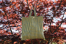 Load image into Gallery viewer, bertie block print bag with blue and yellow gingham in a tree