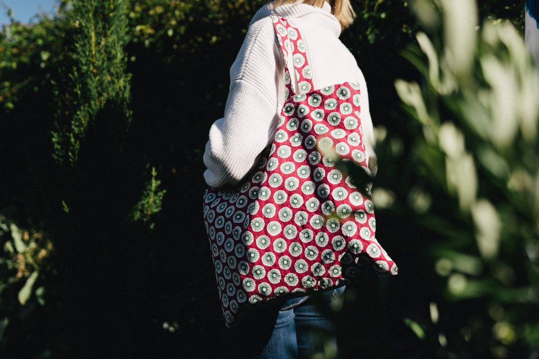 Pink arthus block print bag in situ on a shoulder 